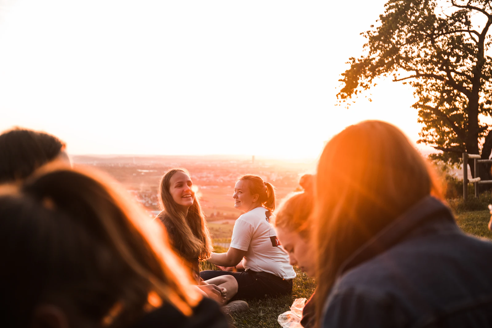 People gathered together outdoors at golden hour